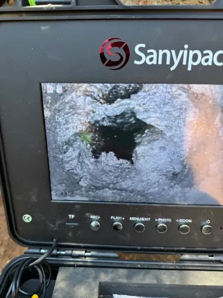 Sewer camera monitor showing the inside of a pipe during an inspection.